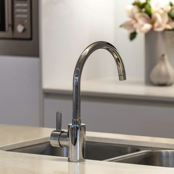 Chrome kitchen faucet over a stainless steel double sink