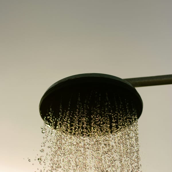 Water falling from a round rain shower head