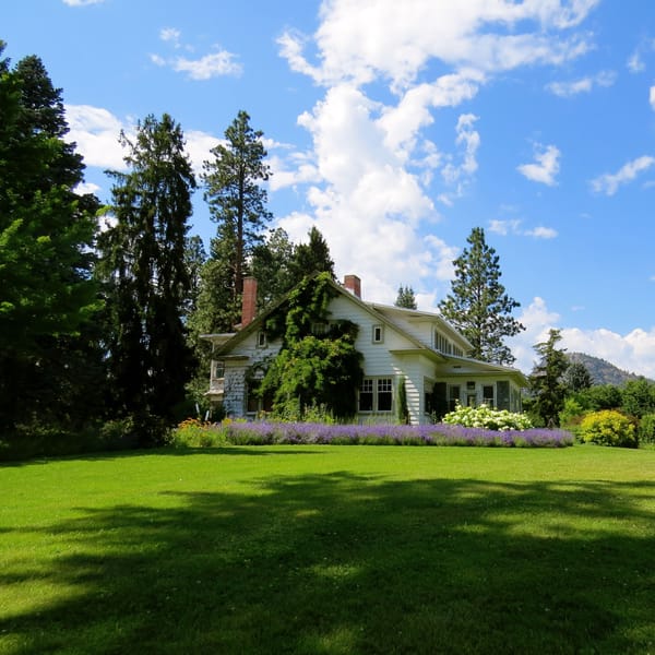 A country home with a large green lawn in daylight